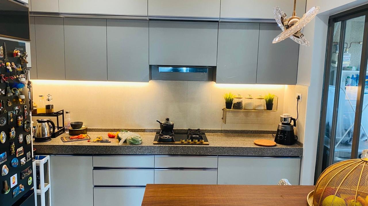 Parallel modular kitchen in soft grey laminate with under-cabinet lighting