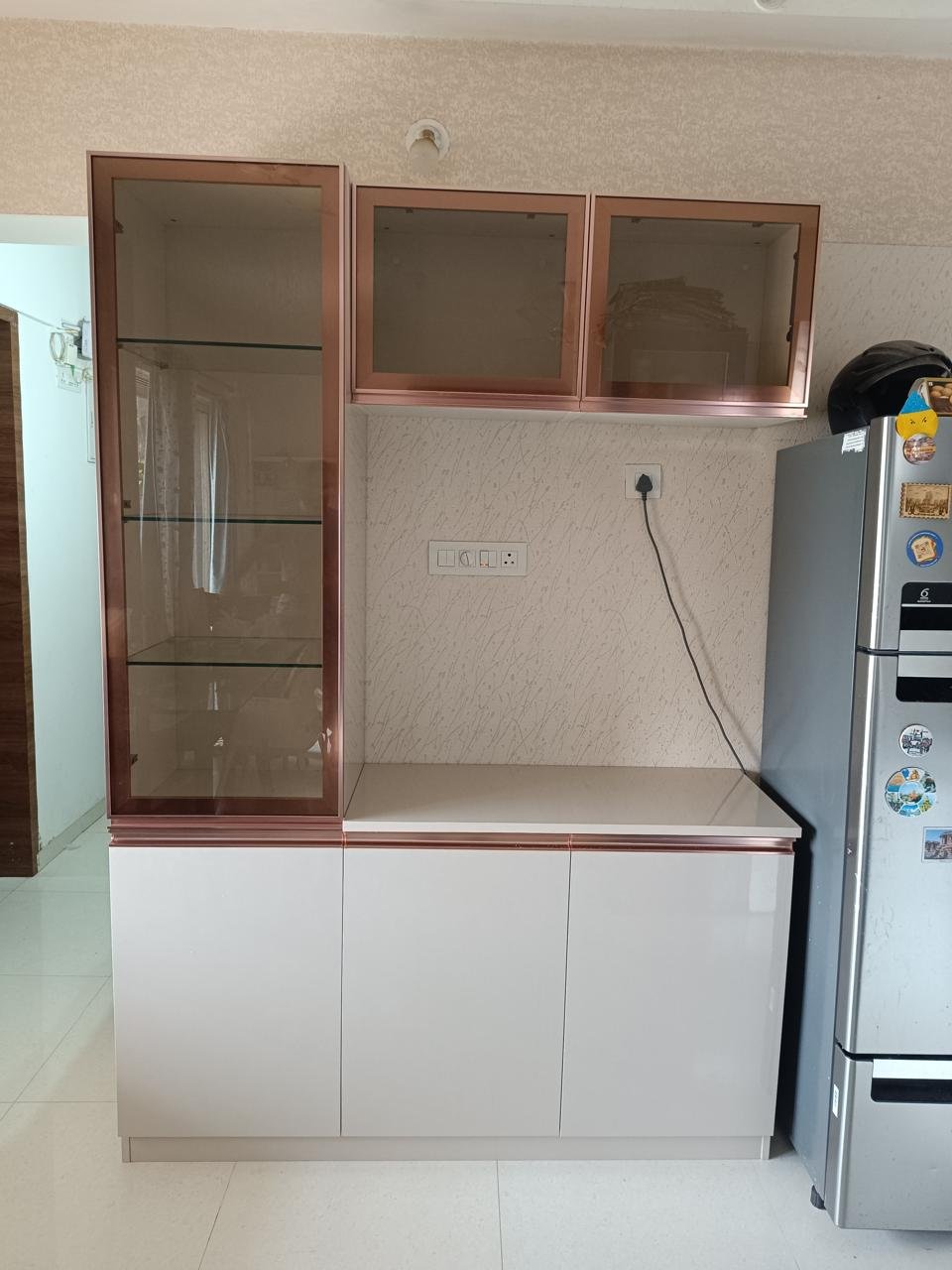 Glass-front crockery and storage unit with a stone countertop
