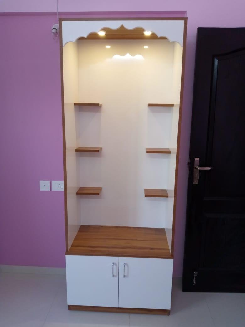 Pooja unit with integrated overhead lighting and open shelves