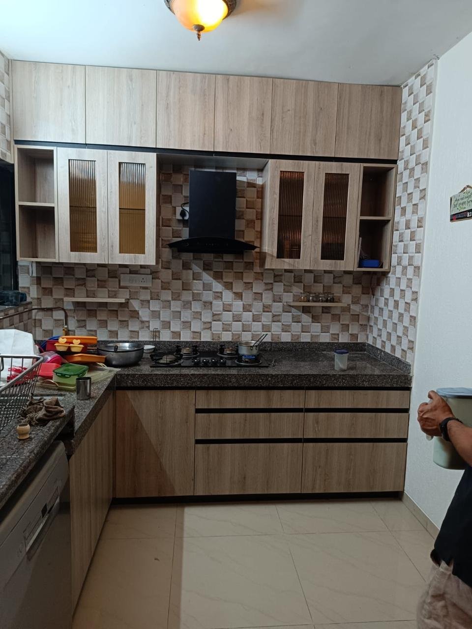 L-shaped modular kitchen in light oak laminate with fluted glass shutters